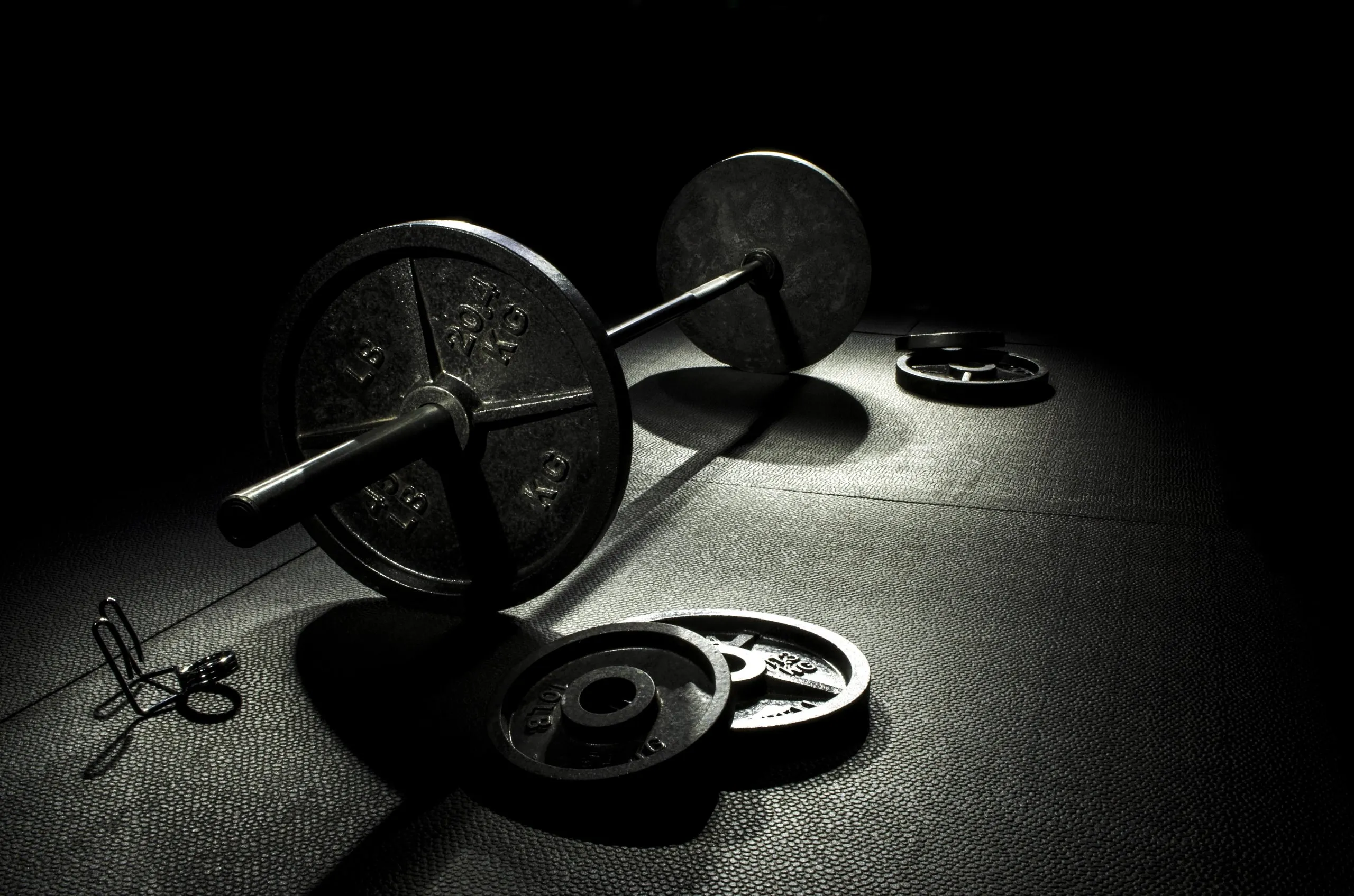 A black and silver weightlifting barbell.